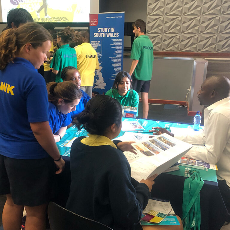 School students meeting a university representative at a Punzila study abroad fair