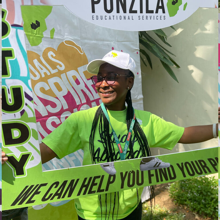 Punzila team member in a Study Abroad photo frame at an expo