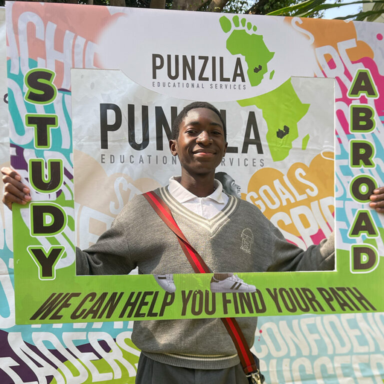 Student in school uniform posing in the Punzila Study Abroad photo frame