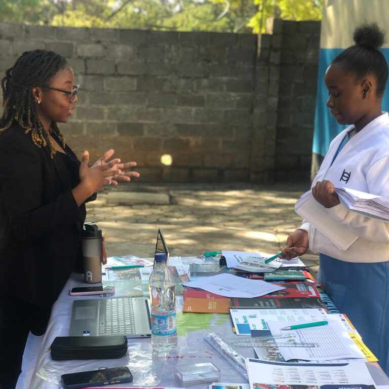 Punzila counsellor talking with a student at a study abroad fair stand