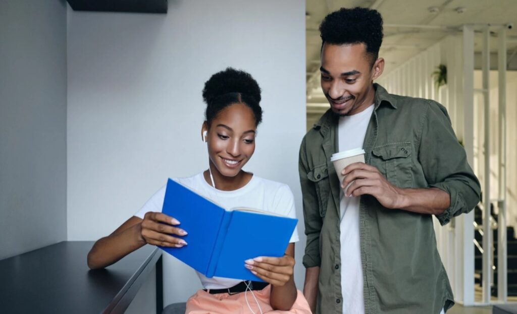 Two students reading a book together