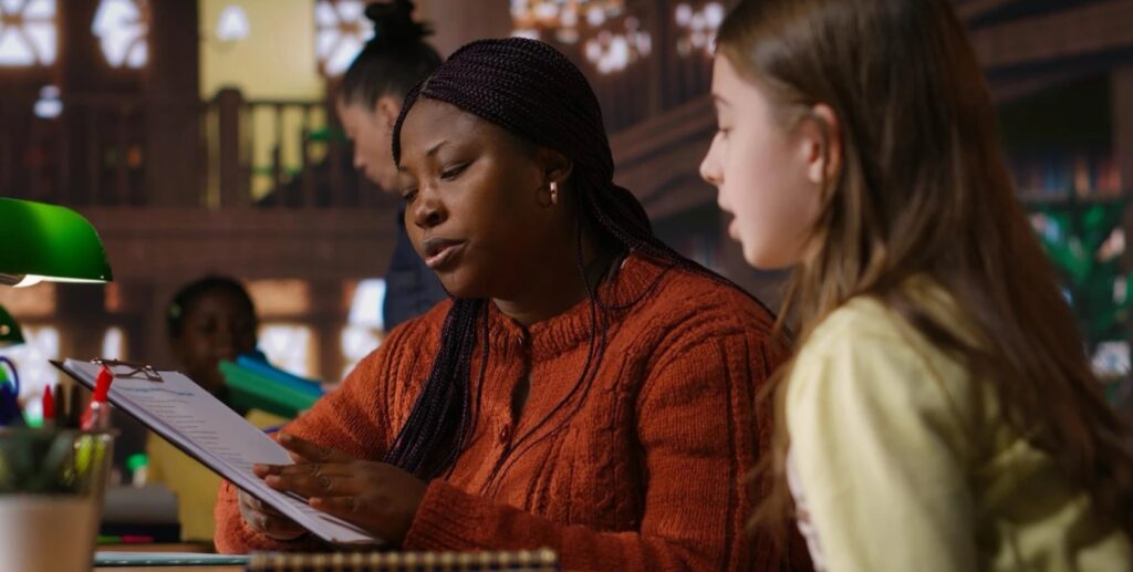 Education counsellor reviewing a document with a student at a library desk